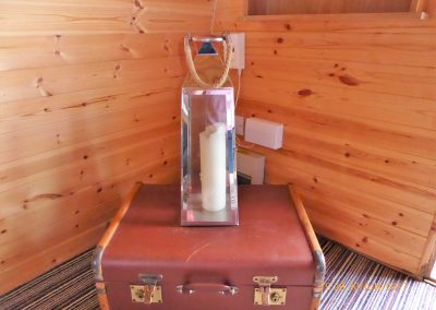 Pitch and Canvas | Glamping and Camping in Cheshire | Lamp and suitcase in luxury pod