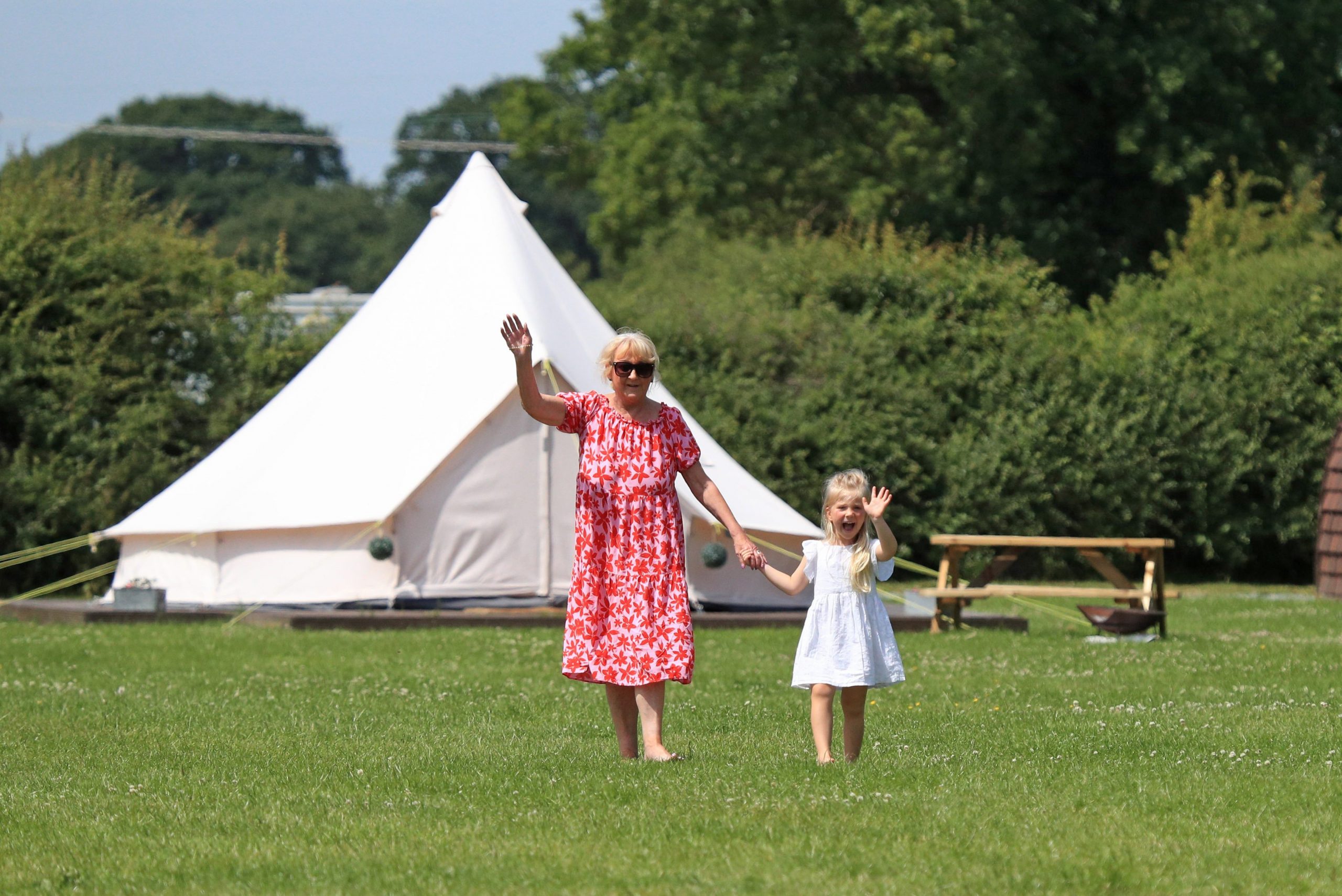 Happy Grandmother and granddaughter outside bell tent